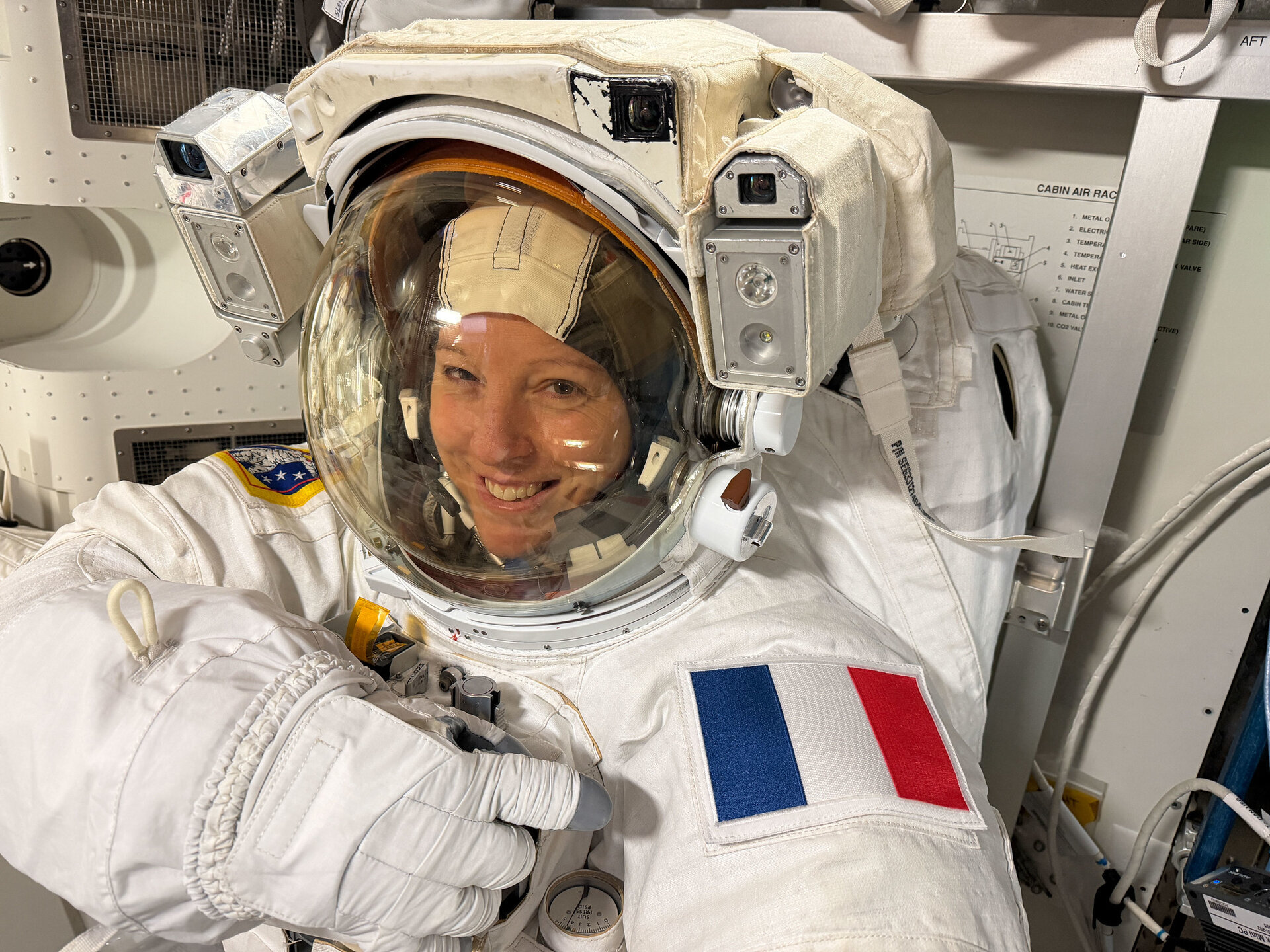 sophie-adenot-checks-spacesuit-pillars